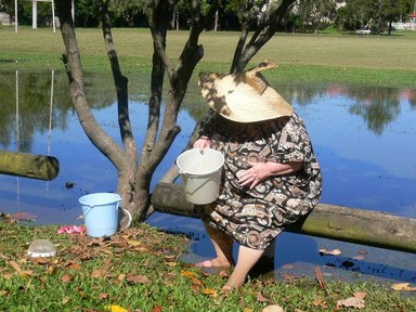 Winifred Struthers; Frog Lady; The lady was collecting frogs and frog spawn from a flooded area to help save the frogs